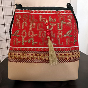 Leather handbag with Armenian fabric